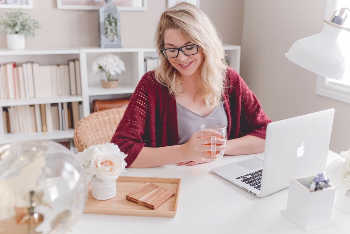 Small business owner working at a desk with a laptop, representing the accessible and friendly nature of Beleaf Bookkeeping Office Hours